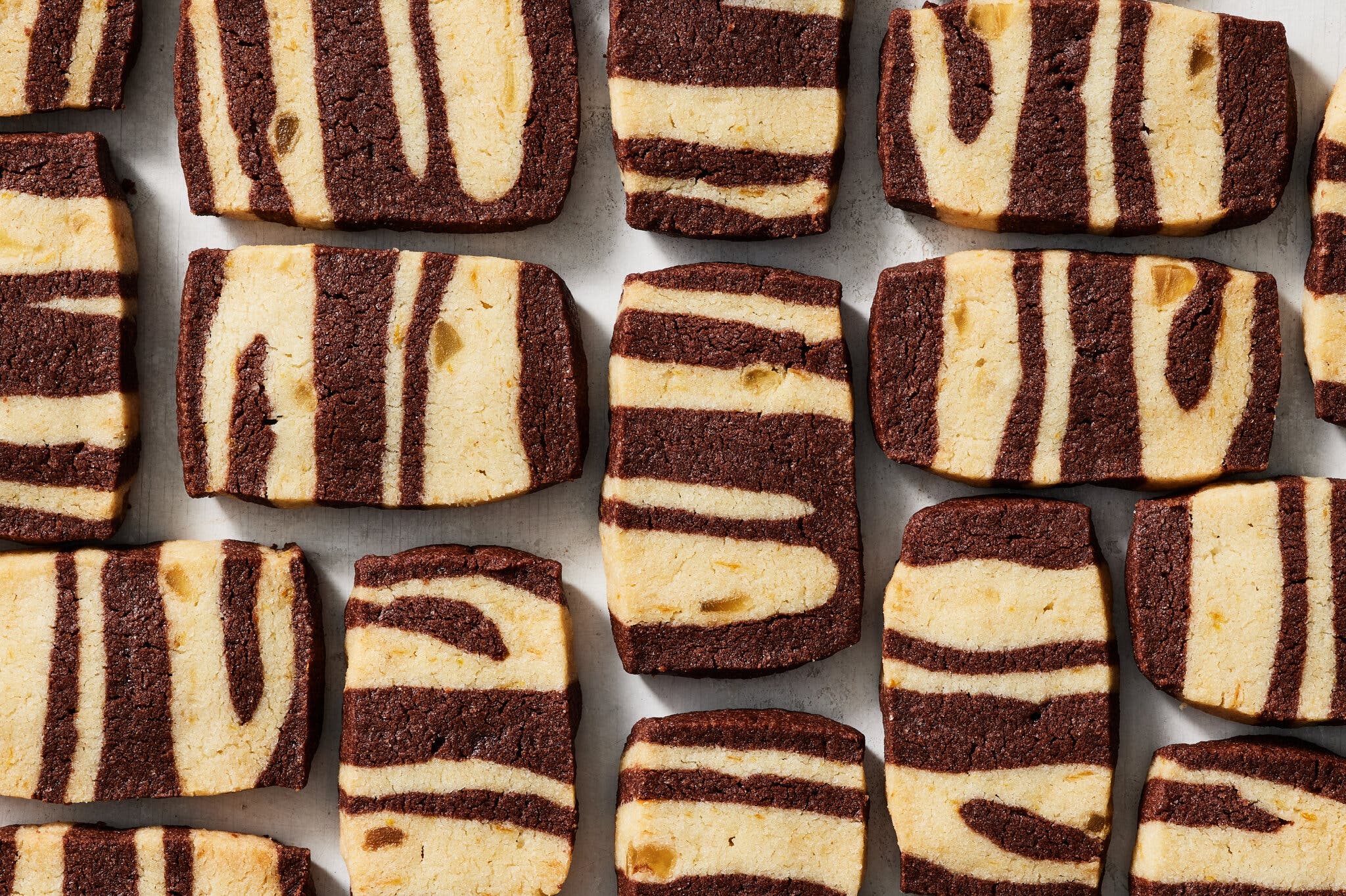An overhead image of rectangular cookies swirled with chocolate and vanilla, and studded with candied ginger.